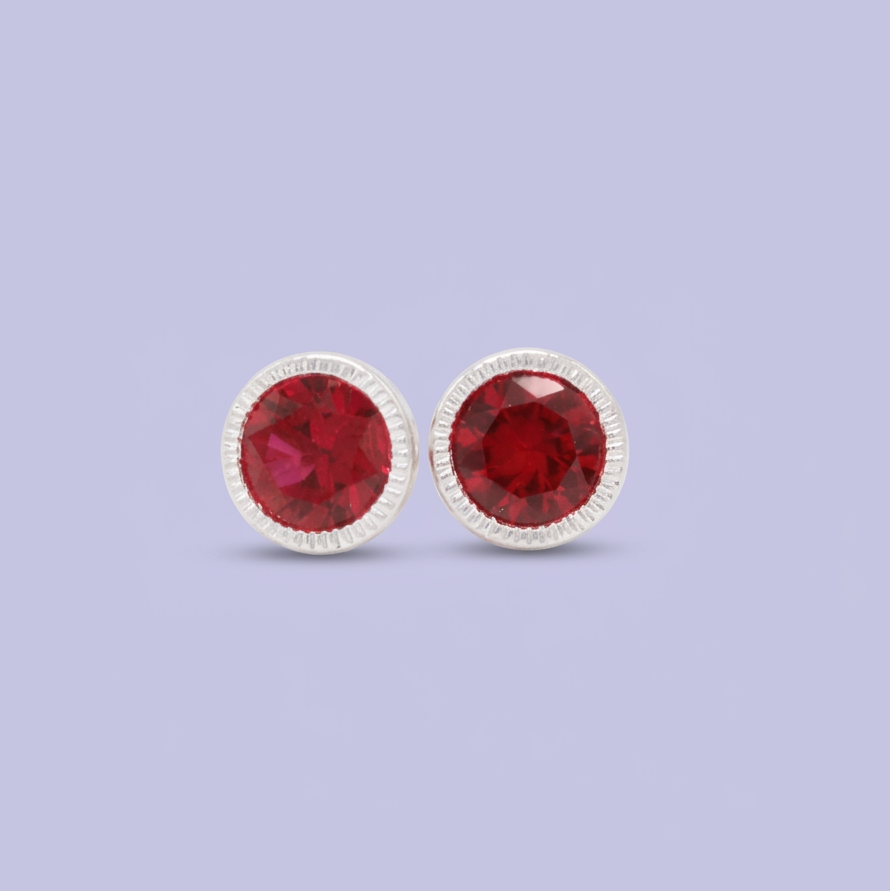 Broquel de Plata .925 Circular con Borde Platedo y Centro de Zirconia Fucsia mod. 3057